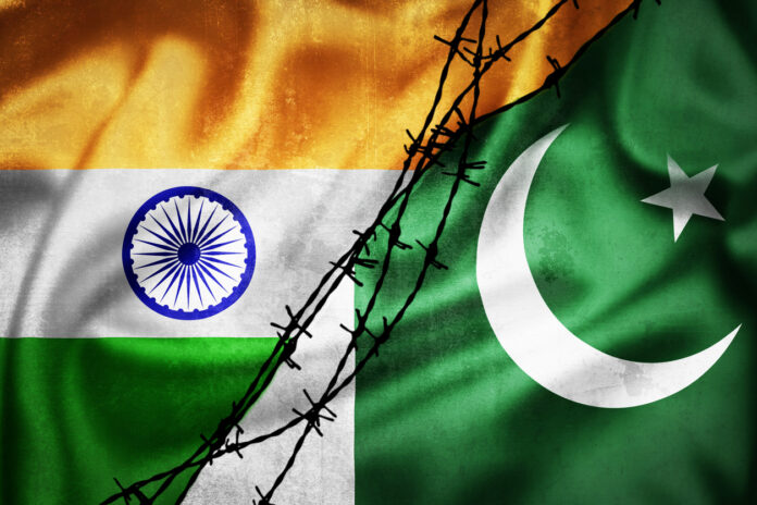 Grunge flags of India and Pakistan divided by barb wire illustration India Pakistan
